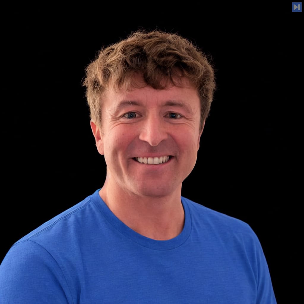 Head-and-shoulders portrait of Andrew Sharp against a black background.