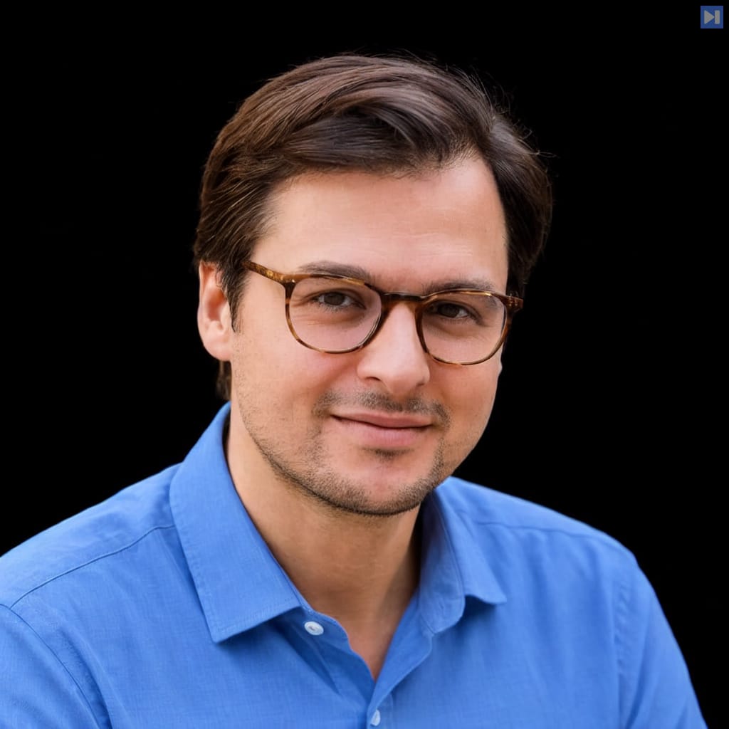 Head-and-shoulders portrait of Armanas Povilionis against a black background.