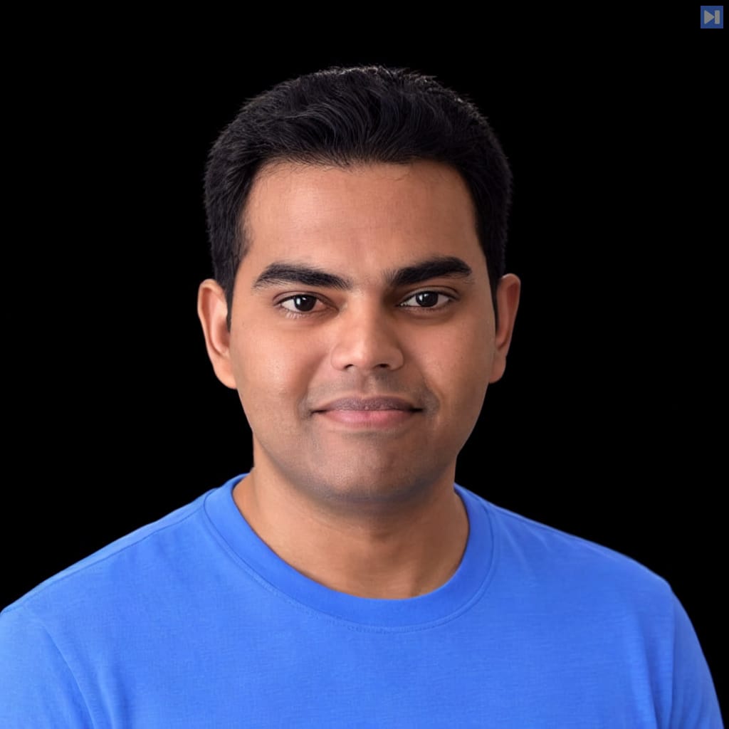 Head-and-shoulders portrait of Ashok Chandrasekar against a black background.