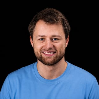 AI-generated portrait of Axel Højmark wearing an AI Videos-blue top against a black background.