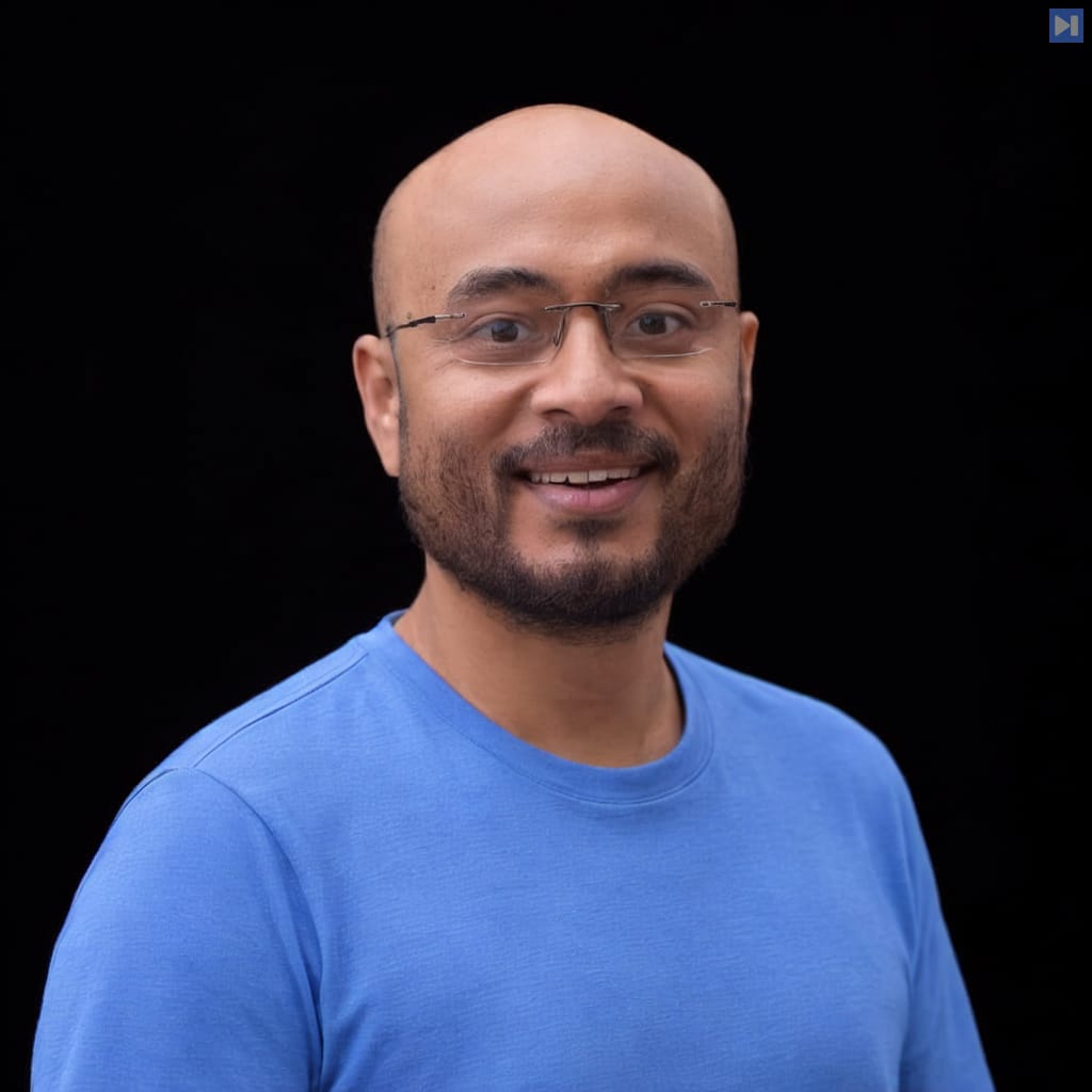 Head-and-shoulders portrait of Ayan Barua against a black background.