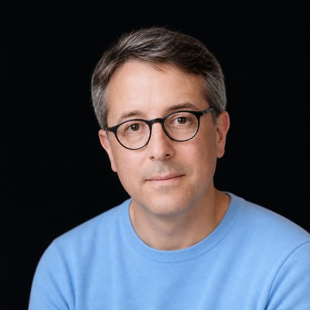 AI-generated portrait of Benedict Evans wearing an AI Videos-blue top against a black background.