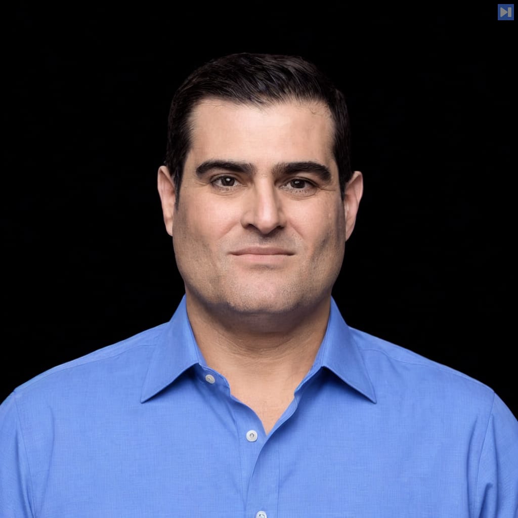 Head-and-shoulders portrait of Brian Keating against a black background.
