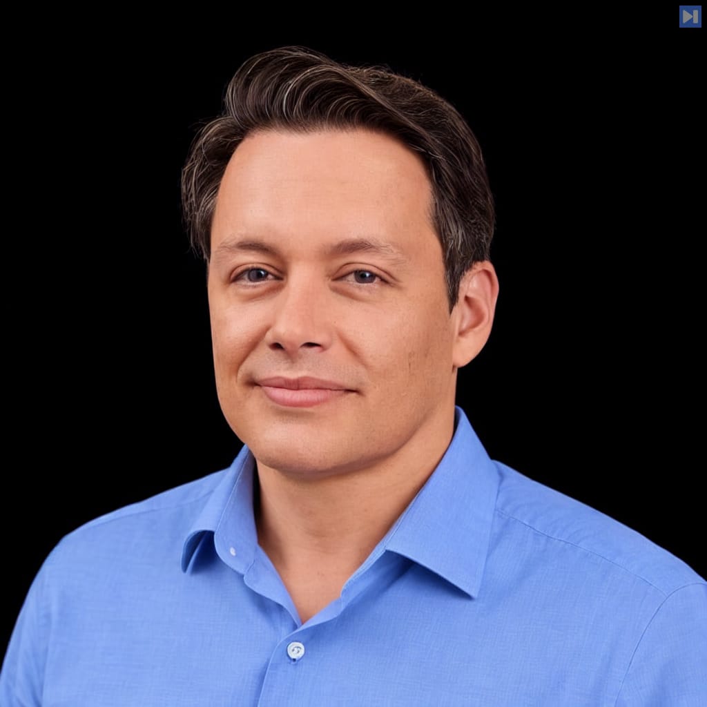 Head-and-shoulders portrait of Cesar Carvalho against a black background.