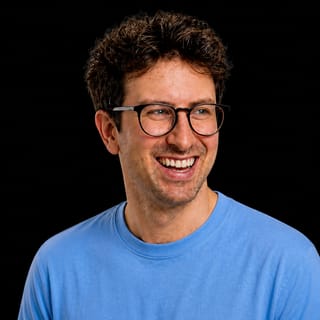 AI-generated portrait of Cody Schneider wearing an AI Videos-blue top against a black background.