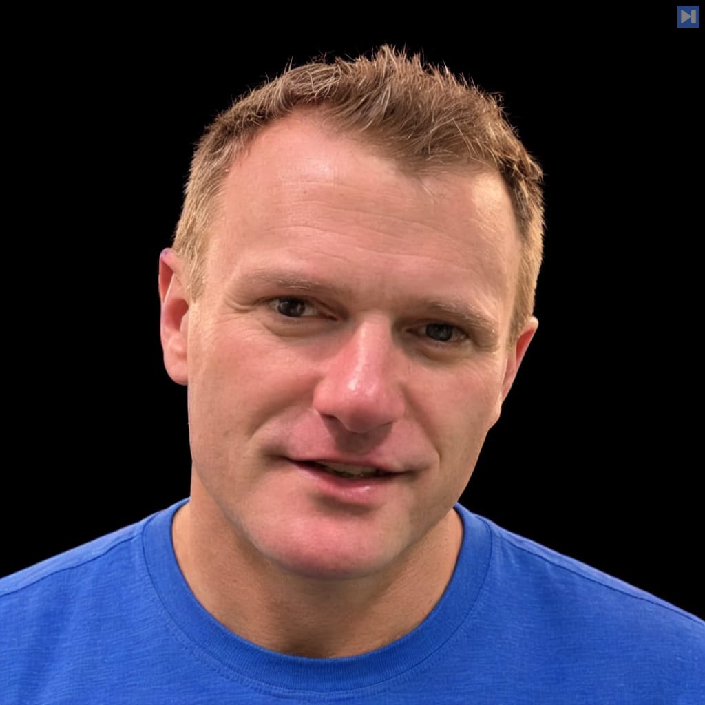 Head-and-shoulders portrait of Cormac Brick against a black background.