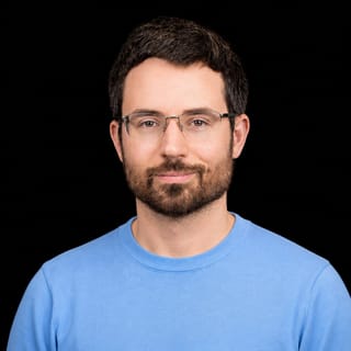 AI-generated portrait of Daniel Kokotajlo wearing an AI Videos-blue top against a black background.