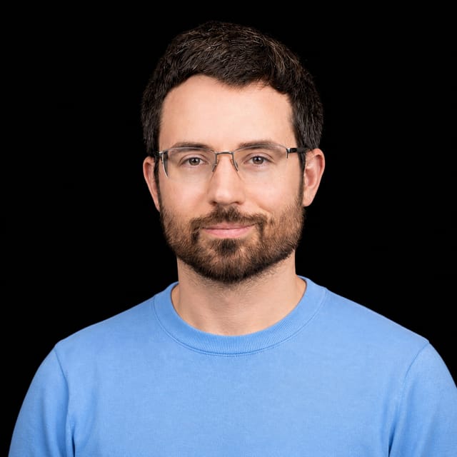 AI-generated portrait of Daniel Kokotajlo wearing an AI Videos-blue top against a black background.