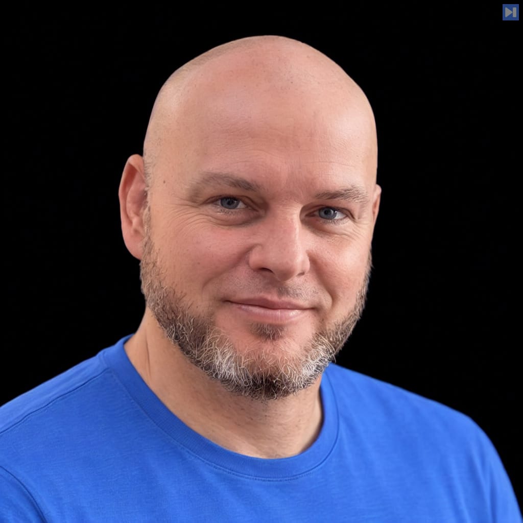 Head-and-shoulders portrait of Daniel Miessler against a black background.