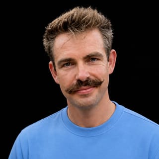 AI-generated portrait of Dex Horthy wearing an AI Videos-blue top against a black background.