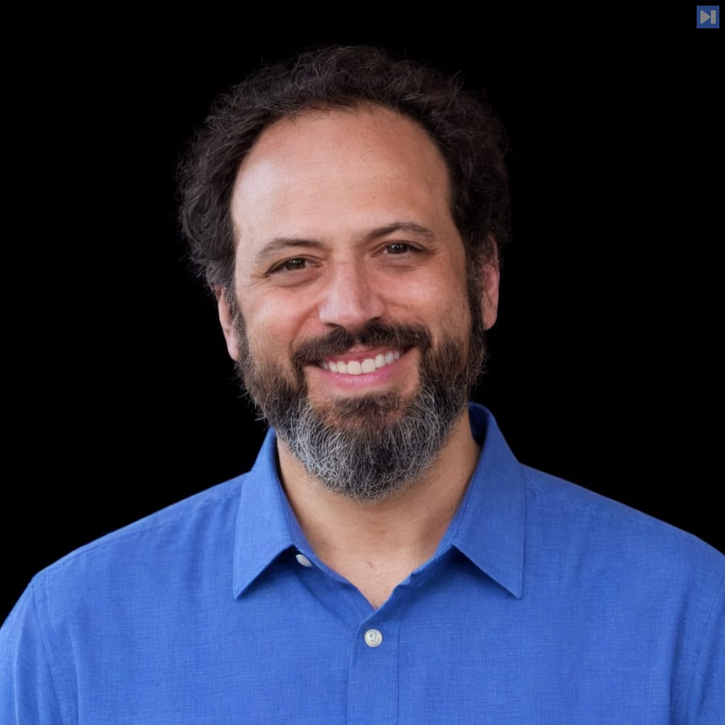Head-and-shoulders portrait of Ethan Mollick against a black background.