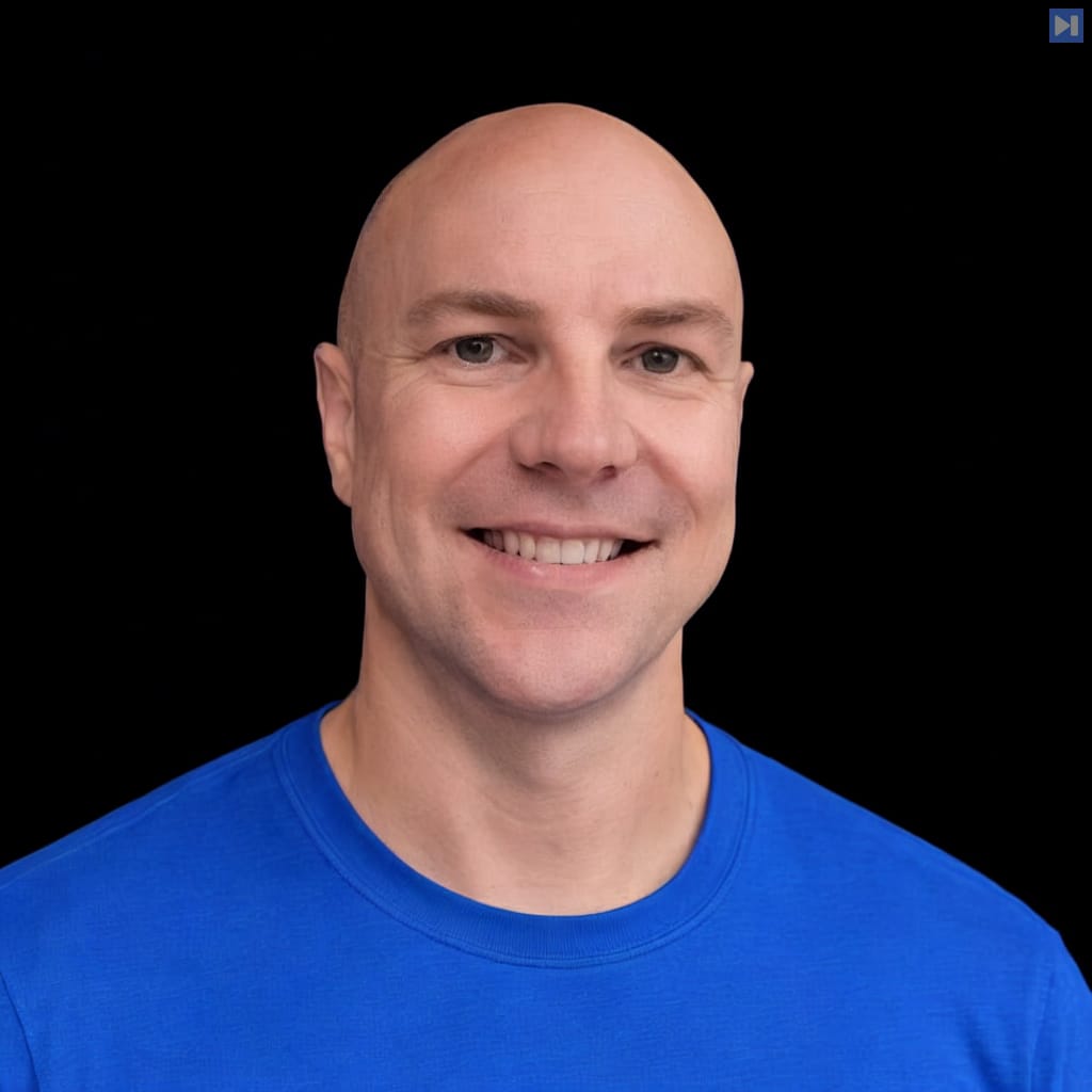 Head-and-shoulders portrait of Evan Kormos against a black background.