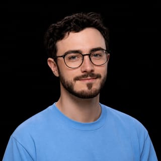 AI-generated portrait of Flo Crivello wearing an AI Videos-blue top against a black background.