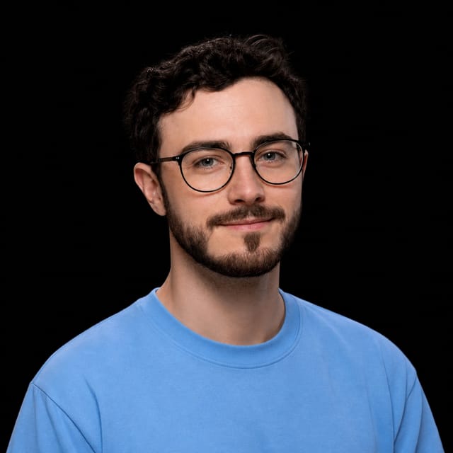 AI-generated portrait of Flo Crivello wearing an AI Videos-blue top against a black background.