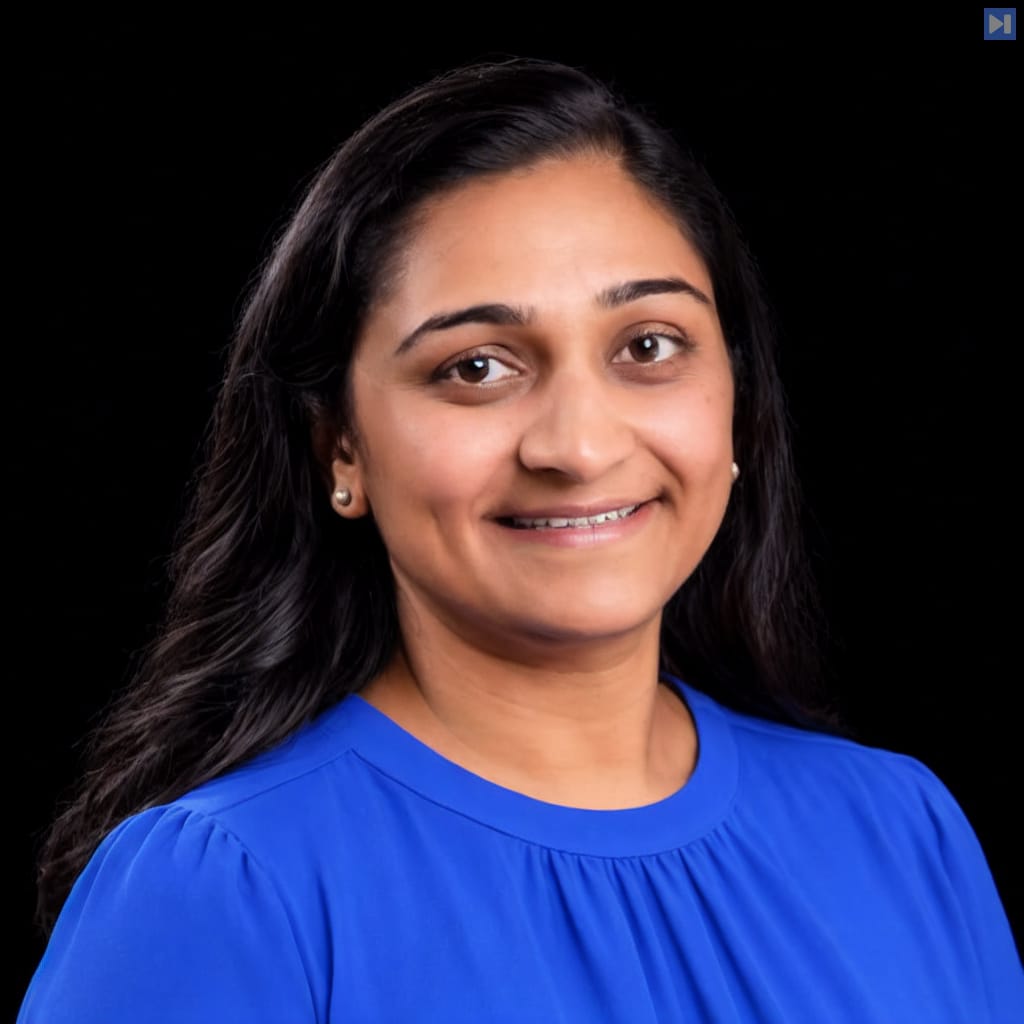 Head-and-shoulders portrait of Hiral Shah against a black background.