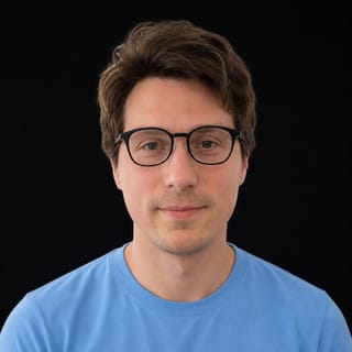 AI-generated portrait of Igor Babuschkin wearing an AI Videos-blue top against a black background.