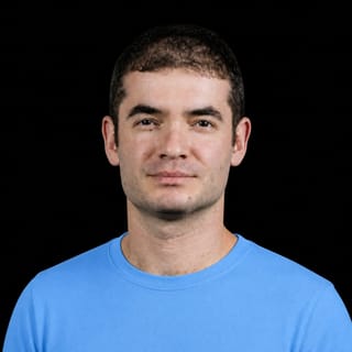 AI-generated portrait of Ilya Sutskever wearing an AI Videos-blue top against a black background.
