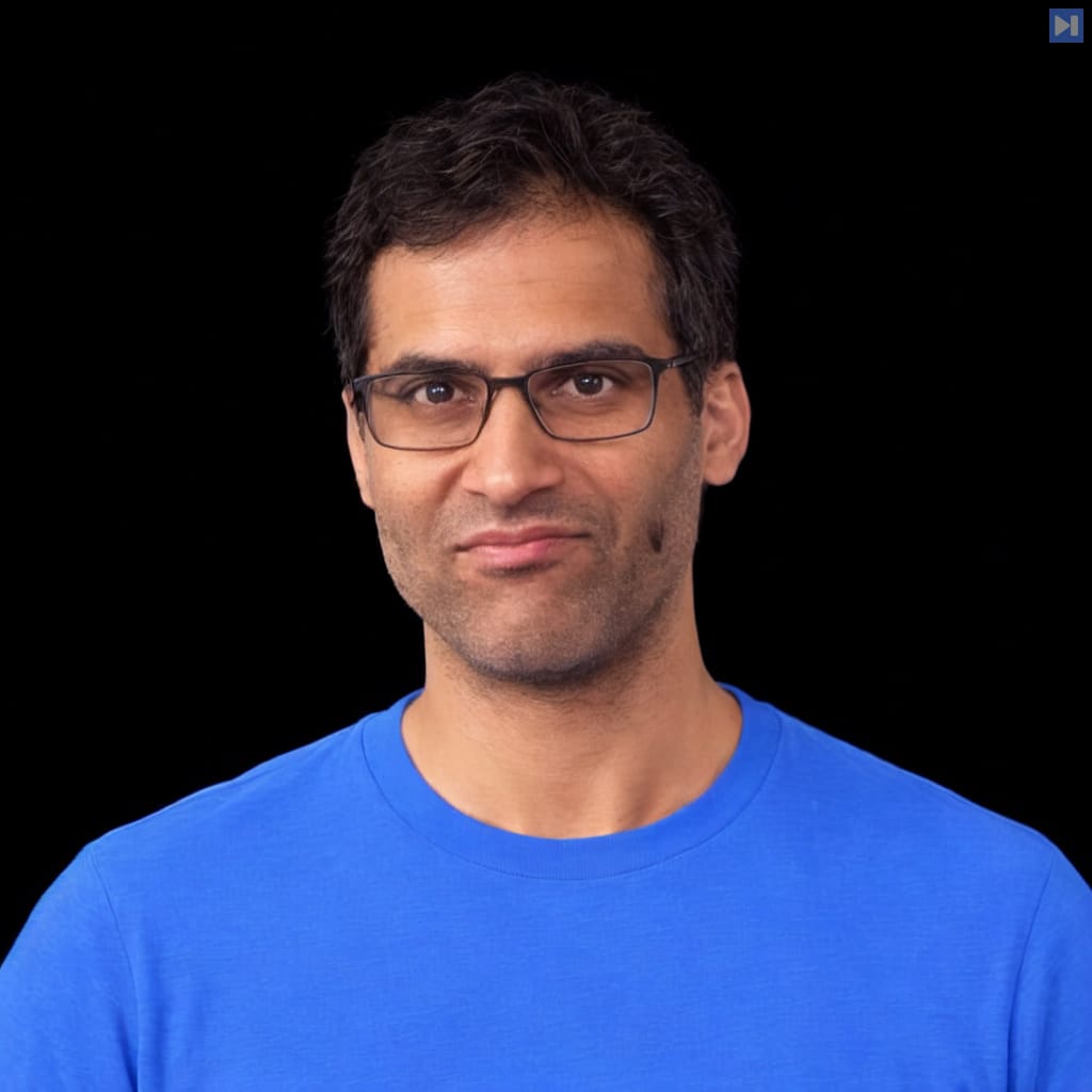 Head-and-shoulders portrait of Ishan Anand against a black background.