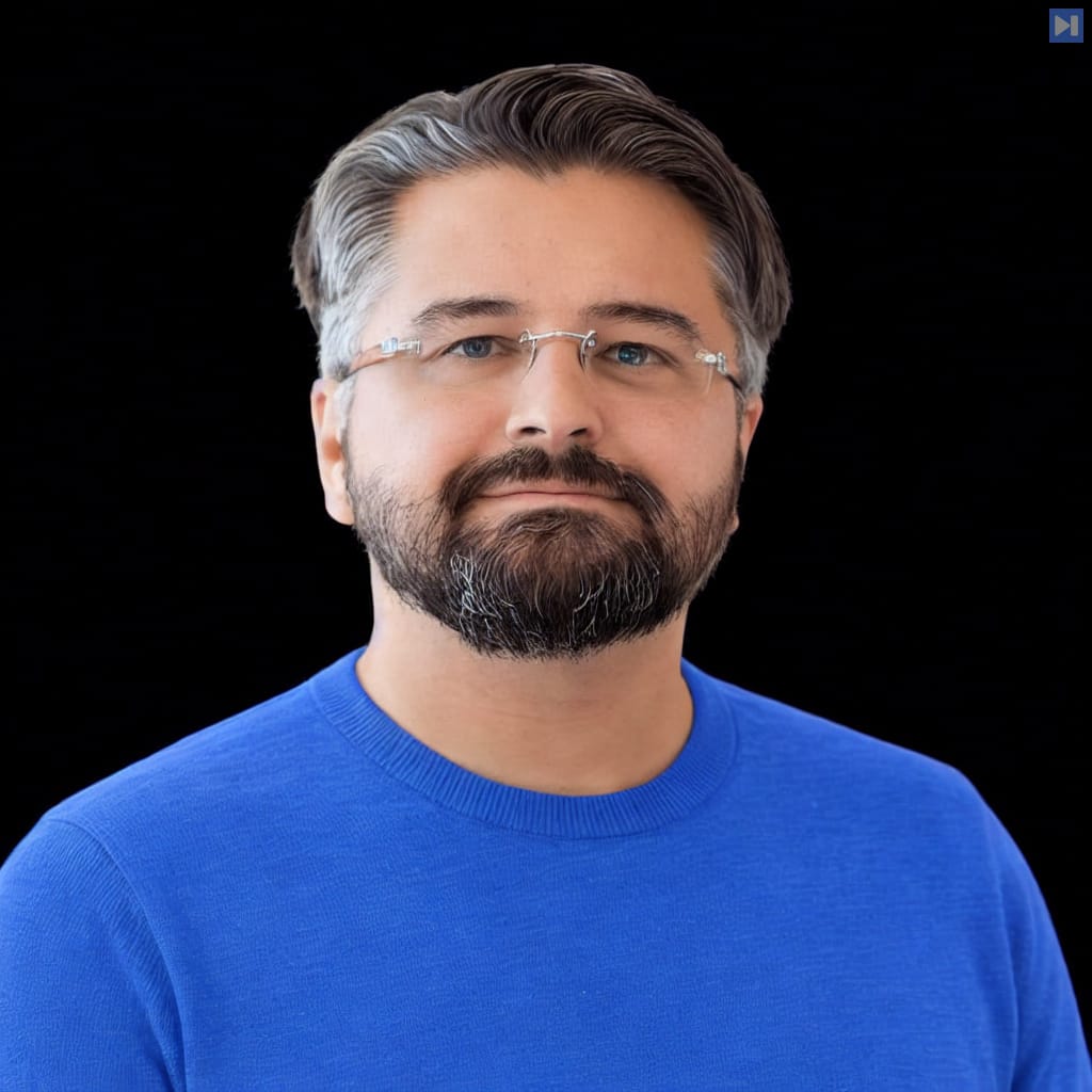 Head-and-shoulders portrait of Joel de la Garza against a black background.
