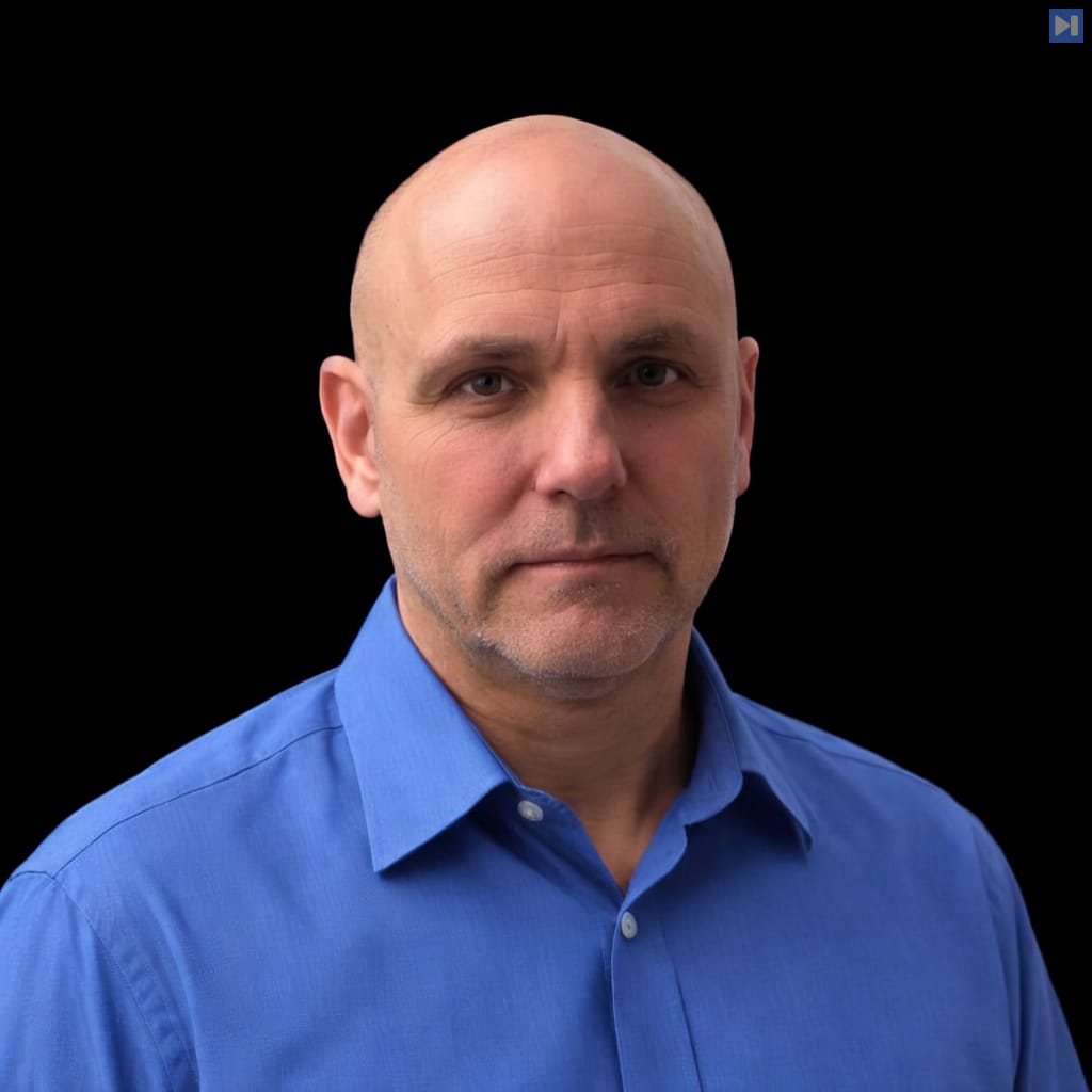 Head-and-shoulders portrait of Kevin Walmsley against a black background.