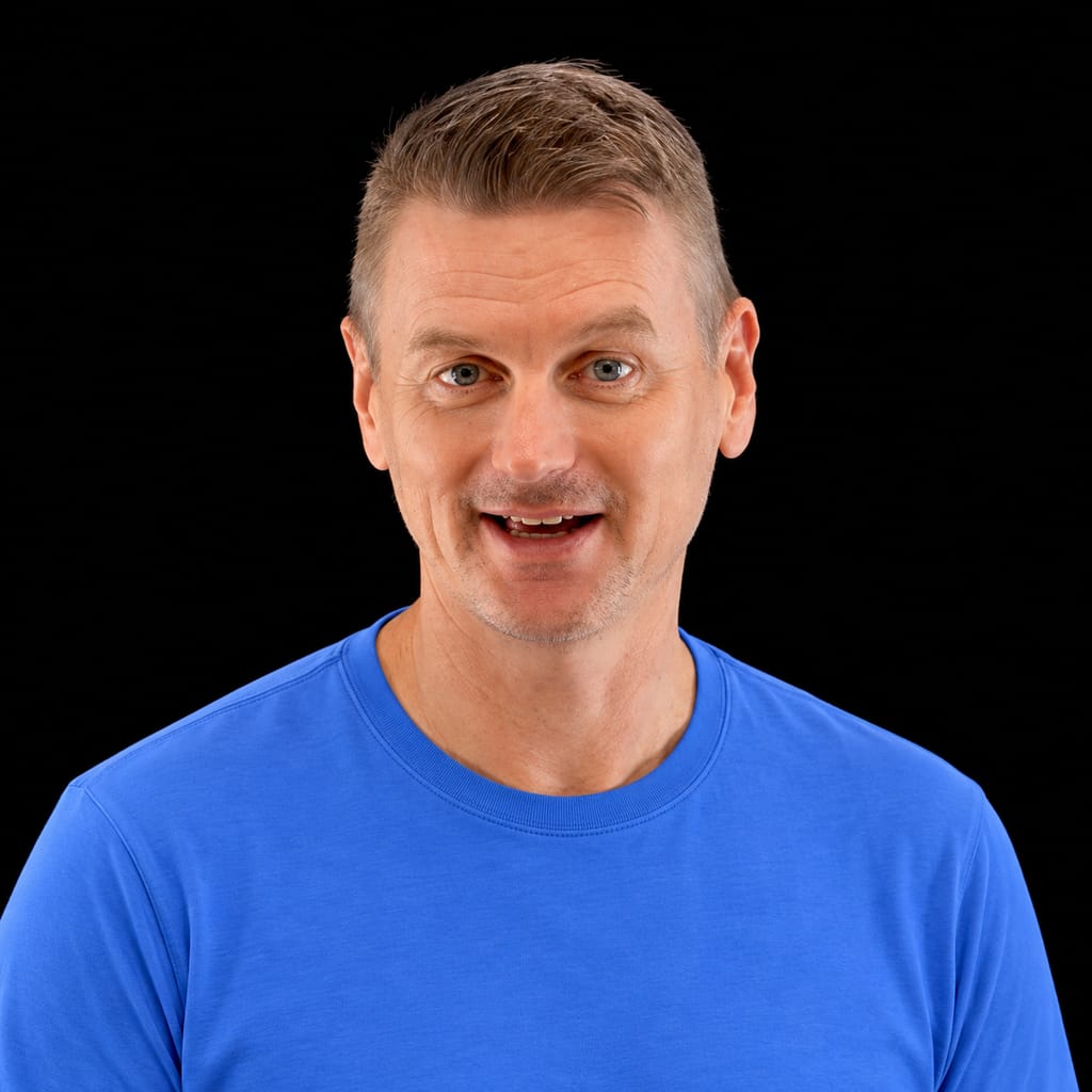 Head-and-shoulders portrait of Martin Keen against a black background.