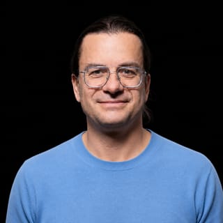 AI-generated portrait of Matthieu Wyart wearing an AI Videos-blue top against a black background.