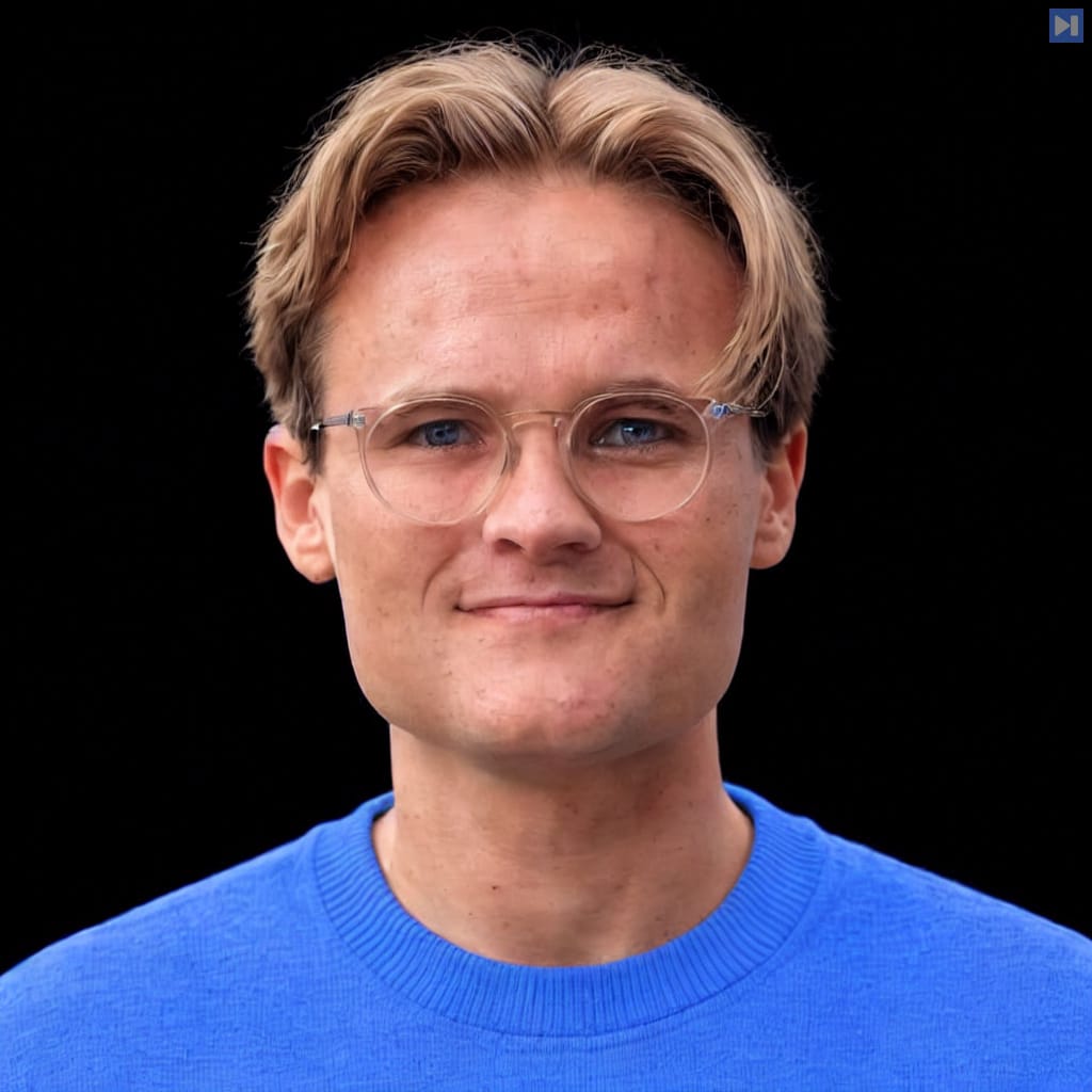 Maximilian-David Rumpf in a plain light attention-blue crewneck, with natural hair highlights and neutral subject lighting against a pure black background.