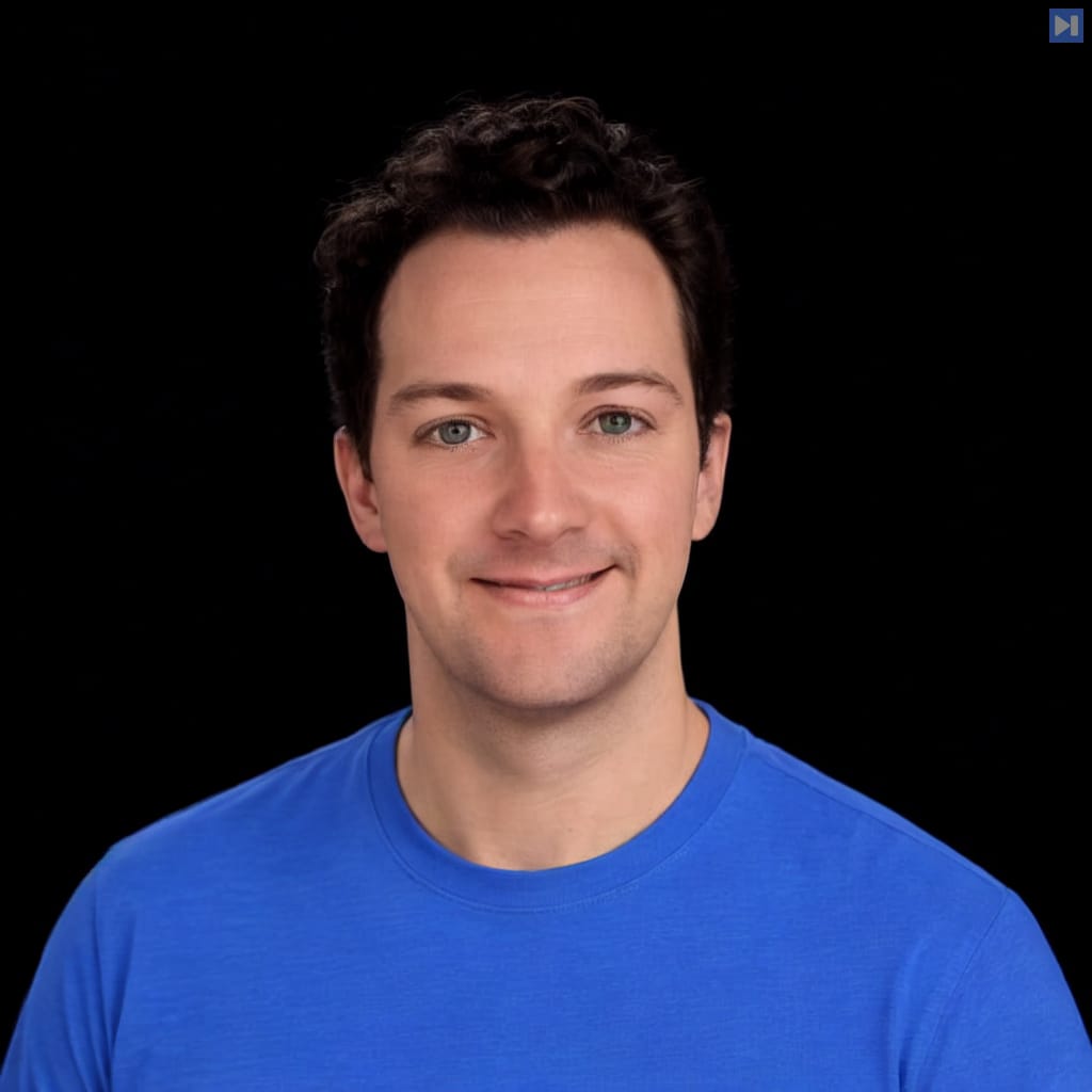 Head-and-shoulders portrait of Michael Grinich against a black background.