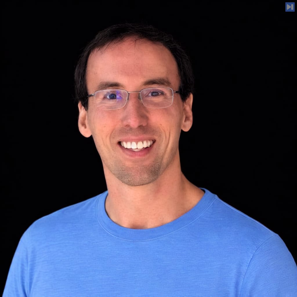 Head-and-shoulders portrait of Mike Phipps against a black background.