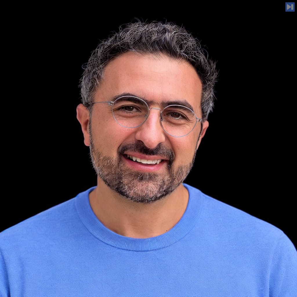 Head-and-shoulders portrait of Mustafa Suleyman against a black background.