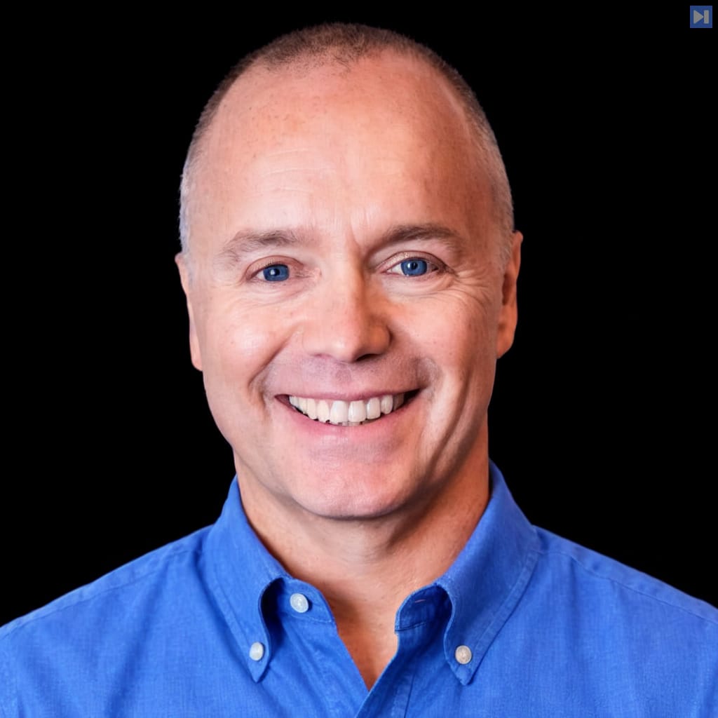 Head-and-shoulders portrait of Phillip Shoemaker against a black background.