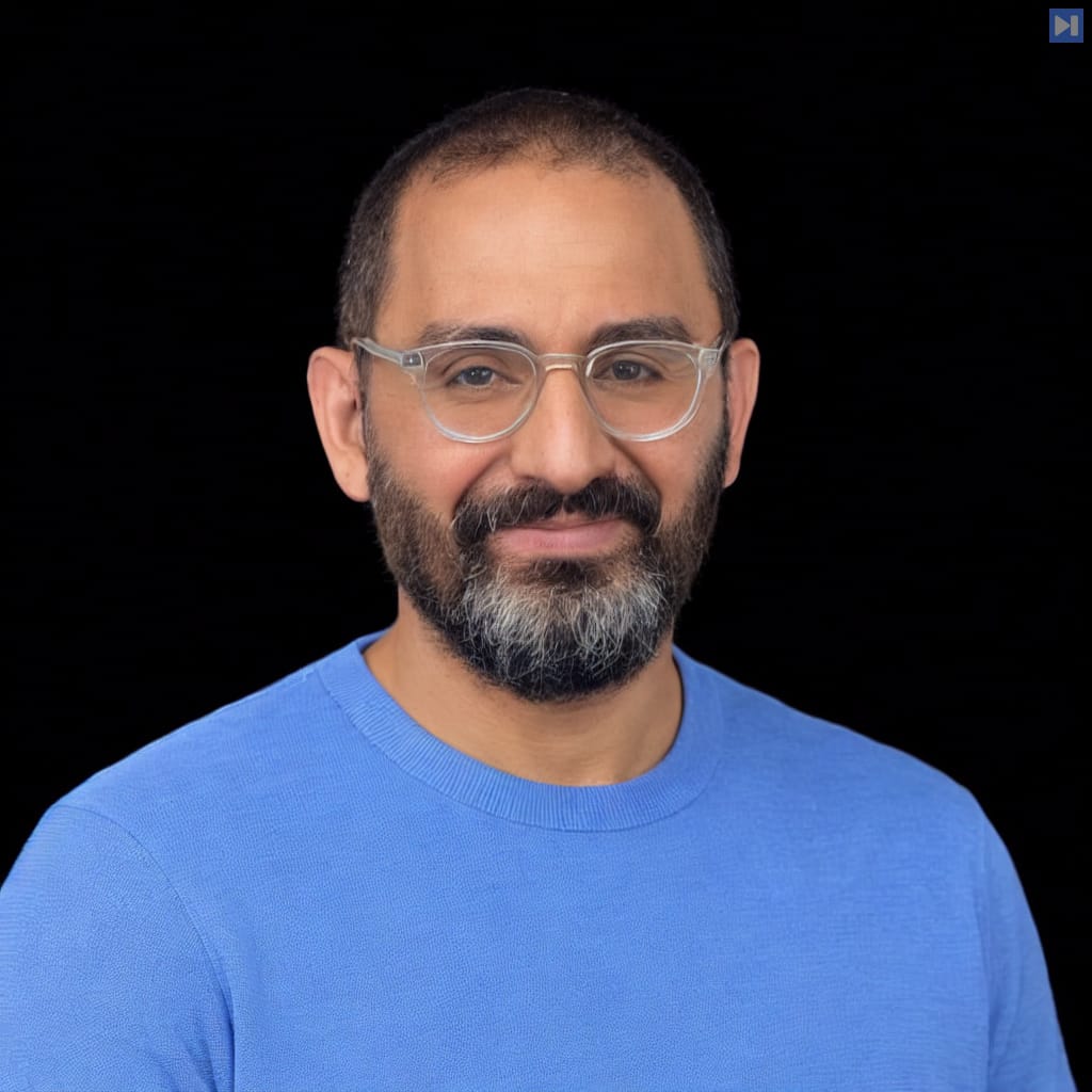 Head-and-shoulders portrait of Raffi Krikorian against a black background.