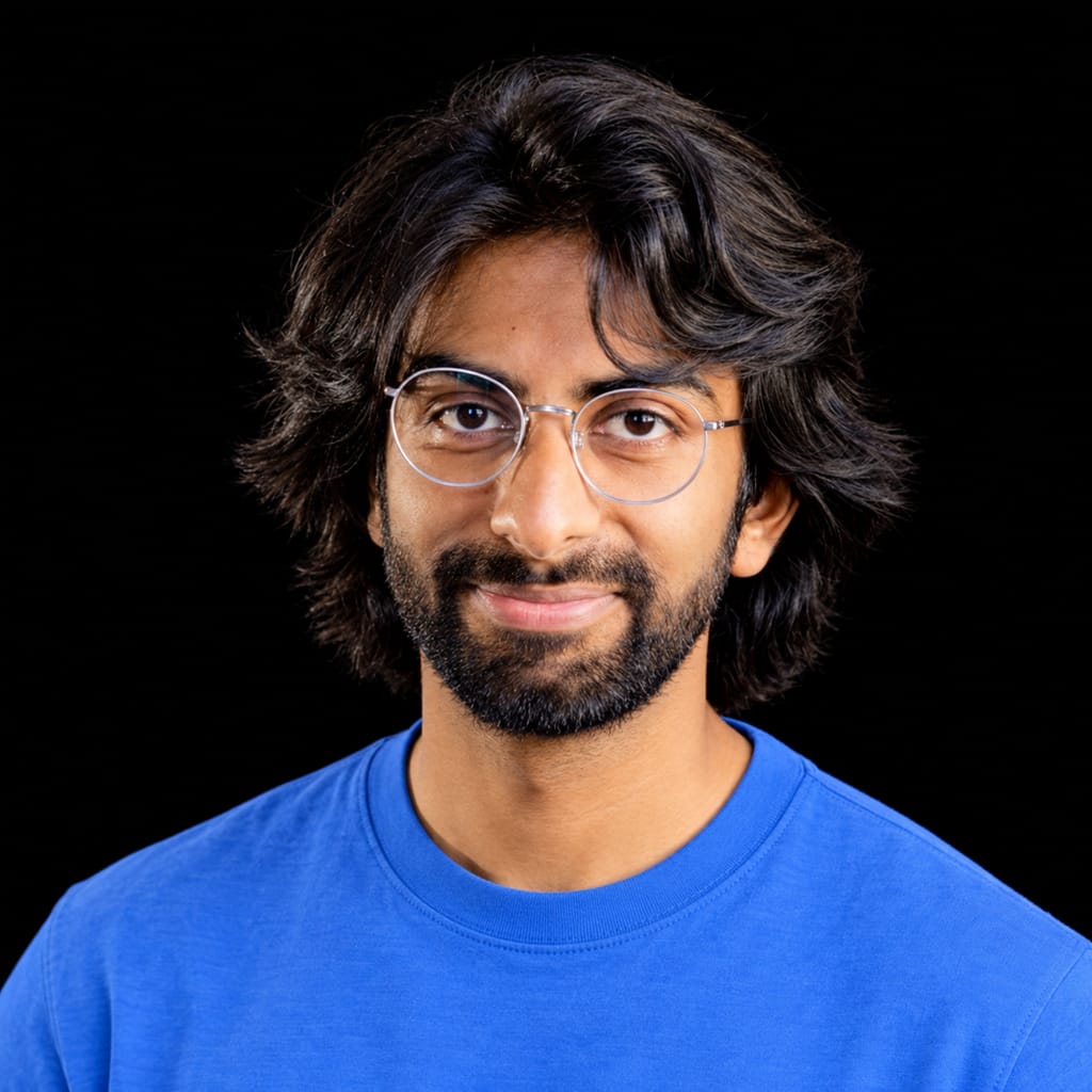 Head-and-shoulders portrait of Rayan Krishnan against a black background.