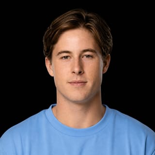 AI-generated portrait of Remy Gaskell wearing an AI Videos-blue top against a black background.