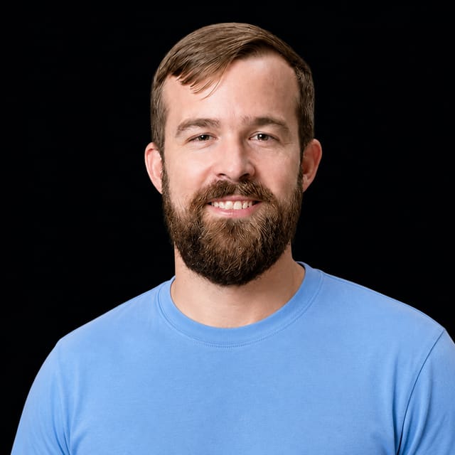 AI-generated portrait of Rob Toews wearing an AI Videos-blue top against a black background.