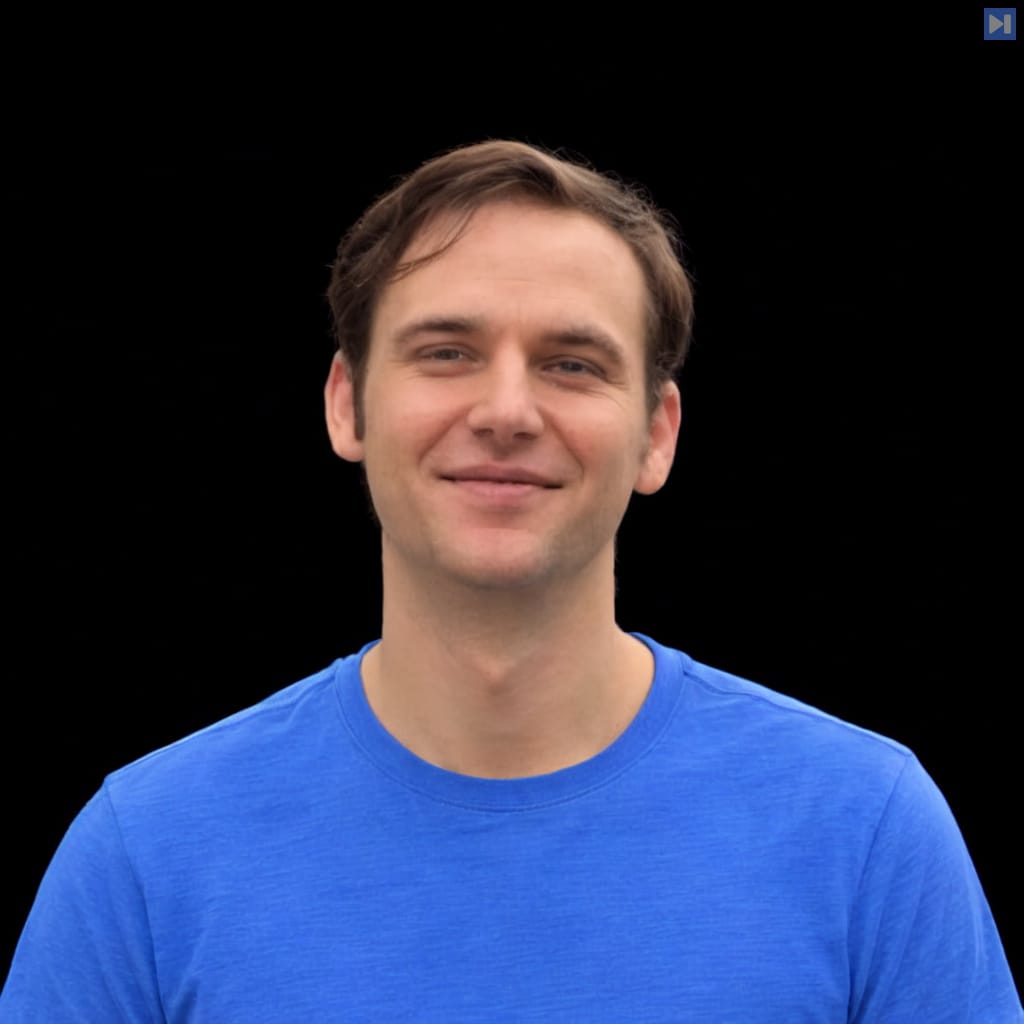 Head-and-shoulders portrait of Ryan Ahern against a black background.