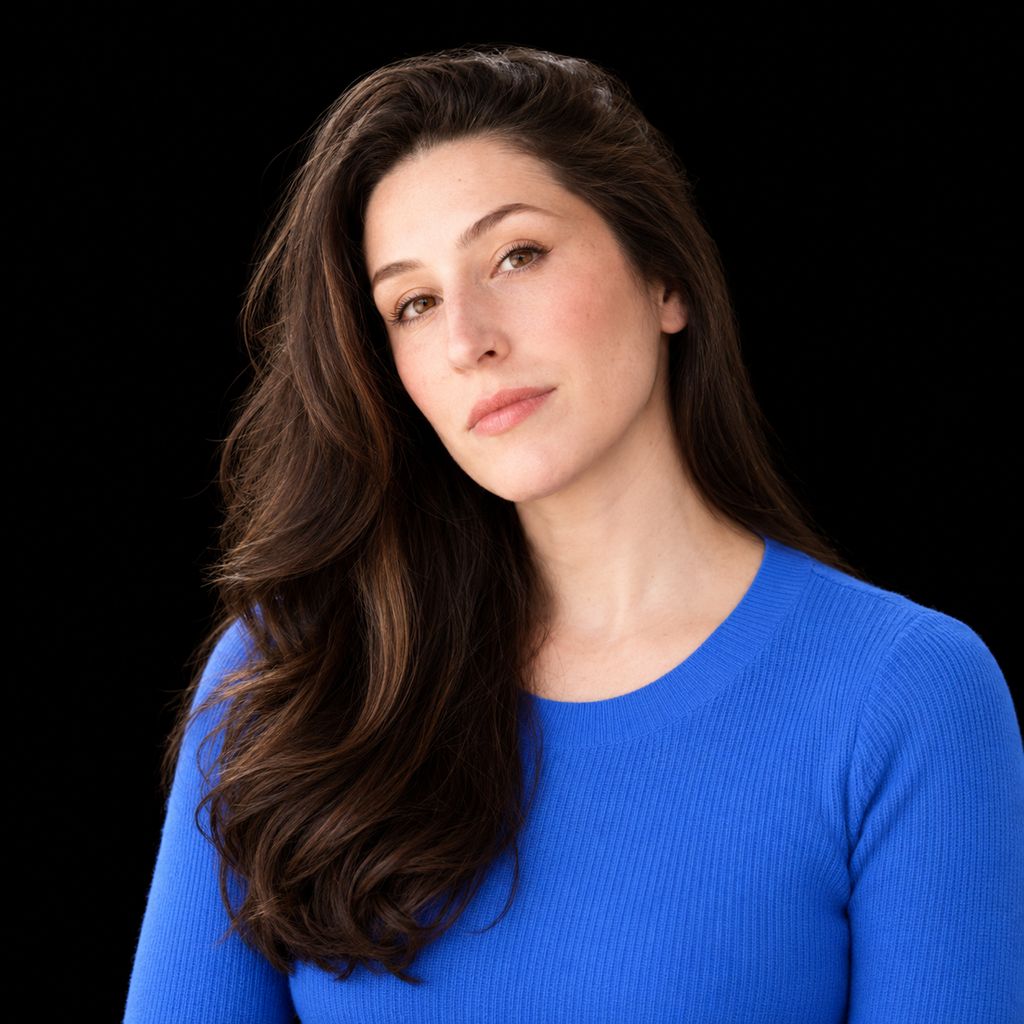 Head-and-shoulders portrait of Sally-Ann DeLucia against a black background.