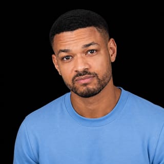 AI-generated portrait of Steven Bartlett wearing an AI Videos-blue top against a black background.