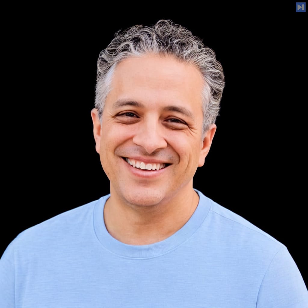 Head-and-shoulders portrait of Tariq Shaukat against a black background.