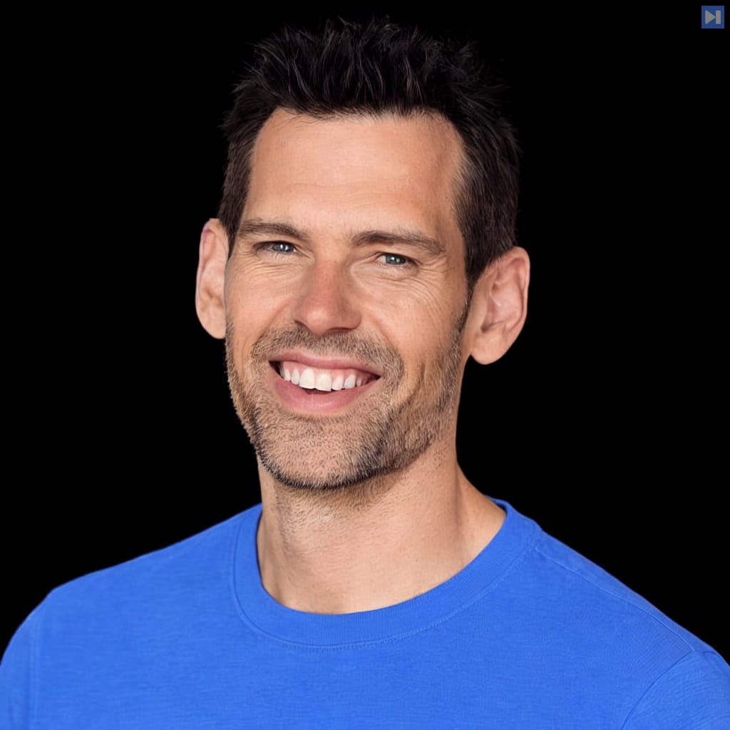 Head-and-shoulders portrait of Tom Bilyeu against a black background.