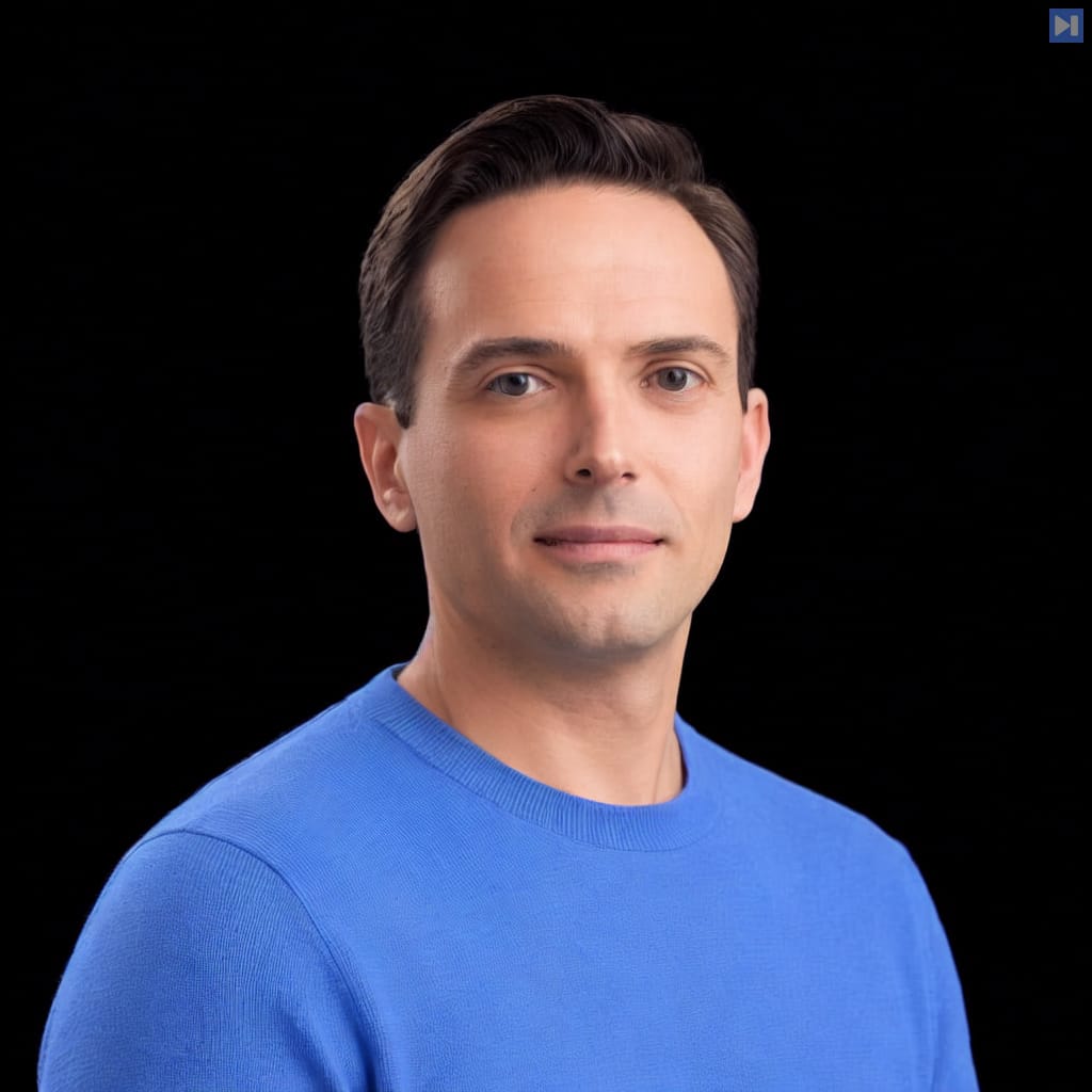 Head-and-shoulders portrait of Tom Mackenzie against a black background.