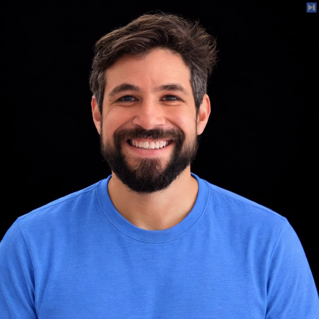 Head-and-shoulders portrait of Tomer Ast against a black background.