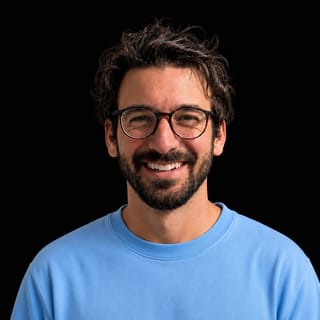 AI-generated portrait of Vince Canger wearing an AI Videos-blue top against a black background.