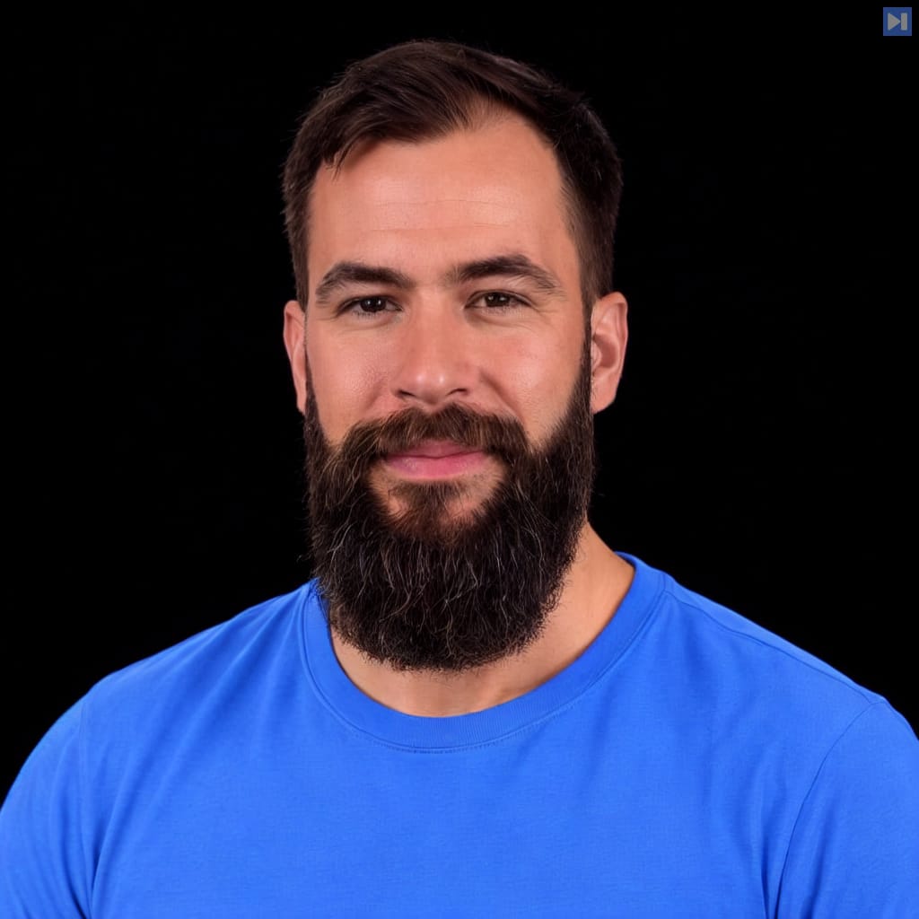 Head-and-shoulders portrait of Vincent Koc wearing a blue T-shirt against a black background.