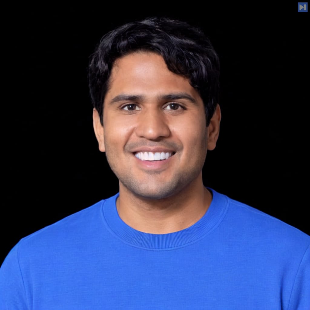 Head-and-shoulders portrait of Vinoo Ganesh against a black background.