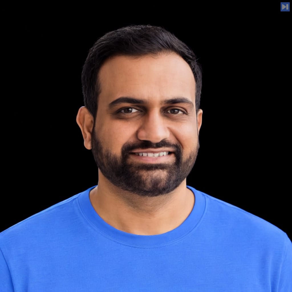 Head-and-shoulders portrait of Yogendra Miraje against a black background.