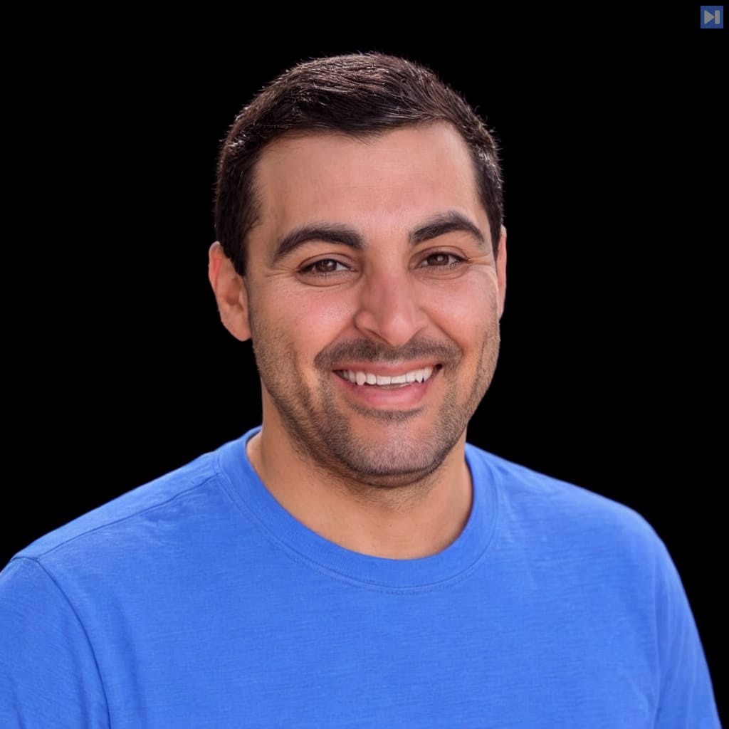 Head-and-shoulders portrait of Yoni Michael against a black background.