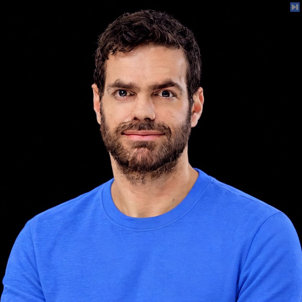 Yuval Belfer in a plain light attention-blue crewneck, with natural hair highlights and neutral subject lighting against a pure black background.